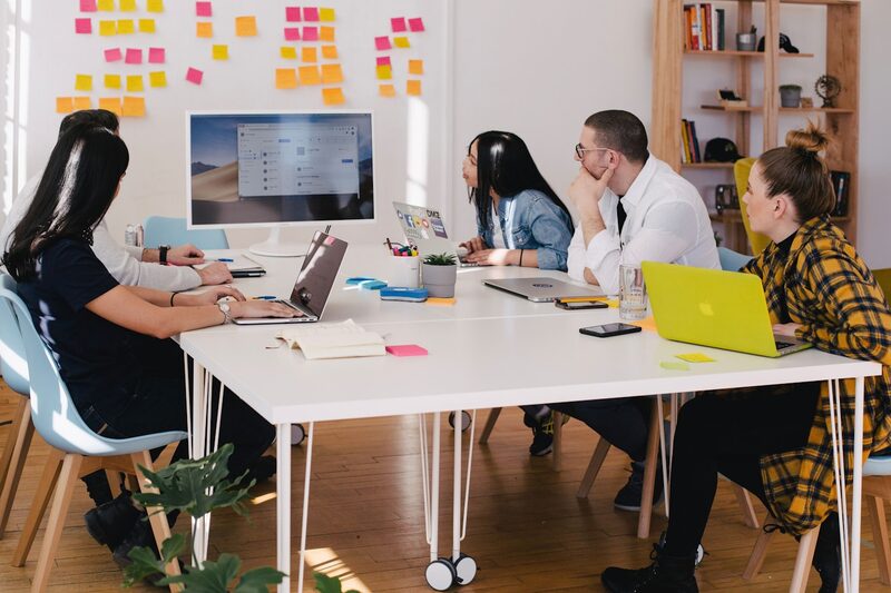 A sales team reviewing territory performance together around a table